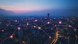 © Teeraphon - Smart digital Innovation city with connection network reciprocity over the cityscape. of future smart wireless city and social media networking systems that connects business people with in city