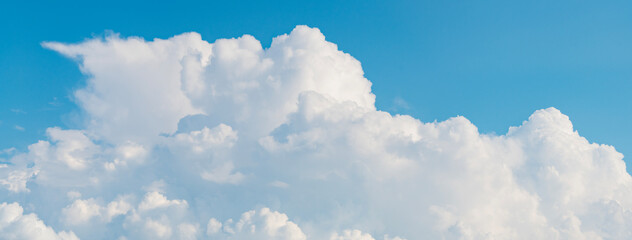 Wall Mural - blue sky with a few clouds. The sky is very bright and the clouds are scattered throughout. Beautiful cloud in blue sky. White fluffy clouds in the sky.