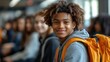 © delvin std - Smiling student in a casual setting with peers.