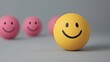 © Pic For You - Bright yellow smiley ball in focus with pink smiley balls in the background, symbolizing happiness and individuality