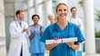 © Hifzhan Graphics - Celebrating a success, a happy nurse in scrubs holding a certificate or award, achievement in healthcare