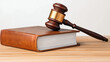 © JK_kyoto - close up of law book with wooden gavel resting on top, symbolizing justice and legal authority