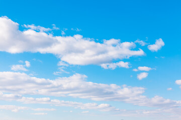 bright blue sky featuring soft white clouds, evoking a sense of tranquility and openness. bright hea