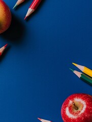 Wall Mural - Colorful Pencils and Apples on Blue - Back to school, education, knowledge, creativity, learning.  Apples and colored pencils on a blue background.