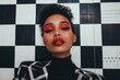© Konstiantyn Zap - Young african female with bold red makeup against checkerboard background