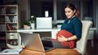 © Chalermrach - Pregnant woman in casual attire working on laptop at home office desk, home, pregnant