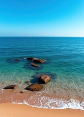 Wall Mural - Beach Wallpaper of The ocean is calm and the water is blue there are rocks in the water and the beach is sandy beach wallpaper summer wallpaper beach background tropical nature