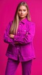 © vstudio - Stylish woman in a vibrant purple pantsuit against a bold pink background.  A confident and modern fashion statement.