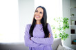 © deagreez - Charming young woman in stylish purple pullover enjoying a relaxing day at home in the living room.