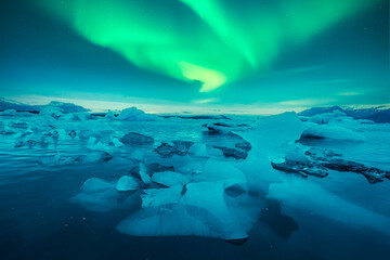 Wall Mural - aurora borealis over jokulsarlon glacial lagoon in iceland. gorgeous icelandic landscape with iceber