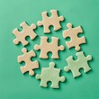 © Cherkasova Alie - he image of the puzzle pieces randomly scattered on a green background creates a playful and attractive visual concept.