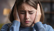© psychoshadow - Upset teenage girl victim of school bullying keeps hands covering ears and eyes closed, feeling discomfort and emotional stress. Sad child feels scared
