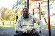 © Marko Geber - Senior man working out with headphones at a park