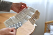 © hanaga - Hands holding instructions for use patient information leaflet and blister pack of pills