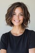 © VISUAL BACKGROUND - A woman in a black shirt smiles at the camera