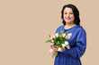 © Pixel-Shot - Happy mature woman with bouquet of beautiful tulips on beige background. International Women's Day