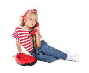 Cute little girl with telephone on white background