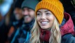 © TeteraX - Woman in orange beanie beams while gathered with friends in a winter setting