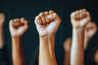 © kristina - Group of people raising fists in protest, standing united with determination and solidarity.