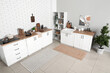 © Pixel-Shot - Kitchen counters with utensils and shelving unit in interior of kitchen