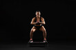 © New Africa - Beautiful woman in sportswear training on black background
