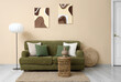 © Pixel-Shot - Interior of living room with green sofa, lamp and paintings