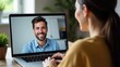 © Helga P-A. - A woman is having a video chat on her laptop with a smiling man visible on the screen. Concept of: Remote connection.