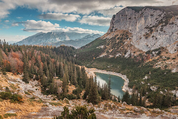 Wall Mural - Colorful autumn foliage surrounds a mountain lake in Durmitor National Park, Montenegro, showing the beauty of the Balkans