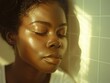 © neatlynatly - A serene image of a young woman with smooth skin and closed eyes, illuminated by soft lighting, casting gentle shadows on a tiled wall.