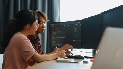 Back end software developer engineer for computer programming working together on debugging writing computing code, solving complex algorithms display on monitor in office. Burgeoning
