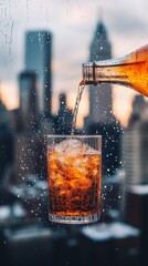 Wall Mural - A glass of soda is poured into a glass, with the city skyline in the background. Concept of relaxation and enjoyment