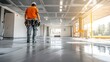 © heinng - Construction Worker Carefully Inspecting Polished Concrete Floor in New Building - Wide Photo. AI Generated