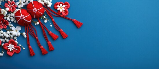 Martisor traditional emblem for Baba Marta holiday celebrating spring with vibrant red decorations and floral motifs on a blue backdrop