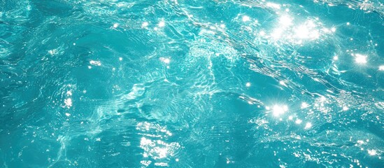 Poster - Turquoise water surface with sparkling reflections creating a glossy shimmering background for design and creative projects