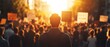 © ธนากร บัวพรหม - A determined individual stands in a crowd during a protest, facing the sunset. Emotion and activism blend under a vibrant sky.