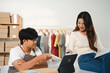 © Fahng - Young business owner of the SME start up company are get purchase orders from customers in the online trading business with a computer laptop in the Home Office