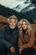 © TP71 - Attractive middle-aged couple, sitting in the mountains wearing autumn clothes. Love in nature concept.
