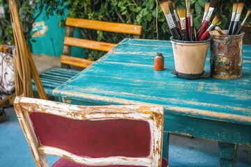 Painting a wooden furniture outdoors- an eco-friendly re-use business.