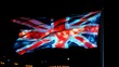 © Joachim - The Union Jack glistens as it waves against a dark night sky, portraying themes of national pride, heritage, and identity, using vibrant colors and motion.