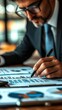 © pimnada - Professional Man in Suit Intently Writing on Paper in Office Setting