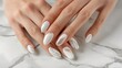 © Mbk - Elegant white nails with geometric silver design.
