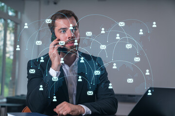 Smiling businessman talking holding using smartphone typing at office workplace with notebook. Concept of distant work, business education. Social network and media net.