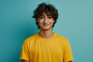 Wall Mural - Portrait of handsome teenager with a smiling face in a green background