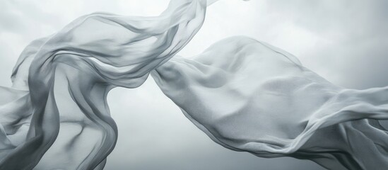 Fototapete - Flowing sheer fabric captured against a dramatic grey sky creating a serene and atmospheric backdrop for design and artistic concepts