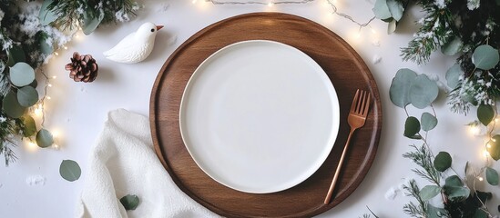 Aufkleber - Elegant flat lay of white plates with copper silverware and greenery adorned with string lights, creating a cozy winter dining atmosphere.