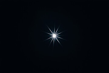 A brilliant starburst light with colorful diffraction lines against a black background.