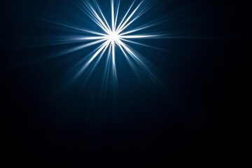 a dazzling starburst light effect featuring colorful diffraction streaks on a black surface.