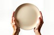 © Pete - Hands hold light beige plate against white background. Empty plate ready for food. Clean, simple image. Food presentation concept. Suitable for menu design, restaurant, cooking related content. Image
