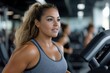 © Milos - A focused woman runs on a treadmill, exuding determination and energy, set against a backdrop of a vibrant gym, showcasing the commitment to her fitness journey.