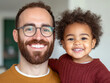© Sergio - Smiling father and child enjoy a joyful moment together in a cozy indoor setting